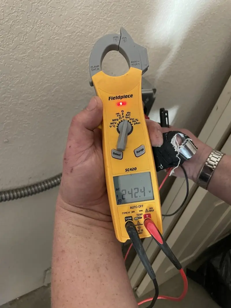 Voltage testing with clamp meter during Generator Installation in Mayflower Village